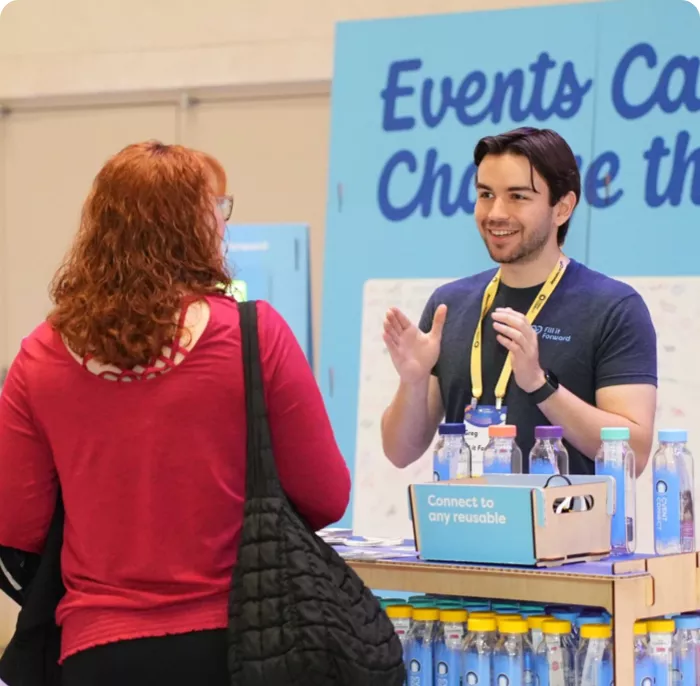 man talking to women at a trade show