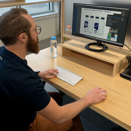 Man working on graphics for Cupanion bottle