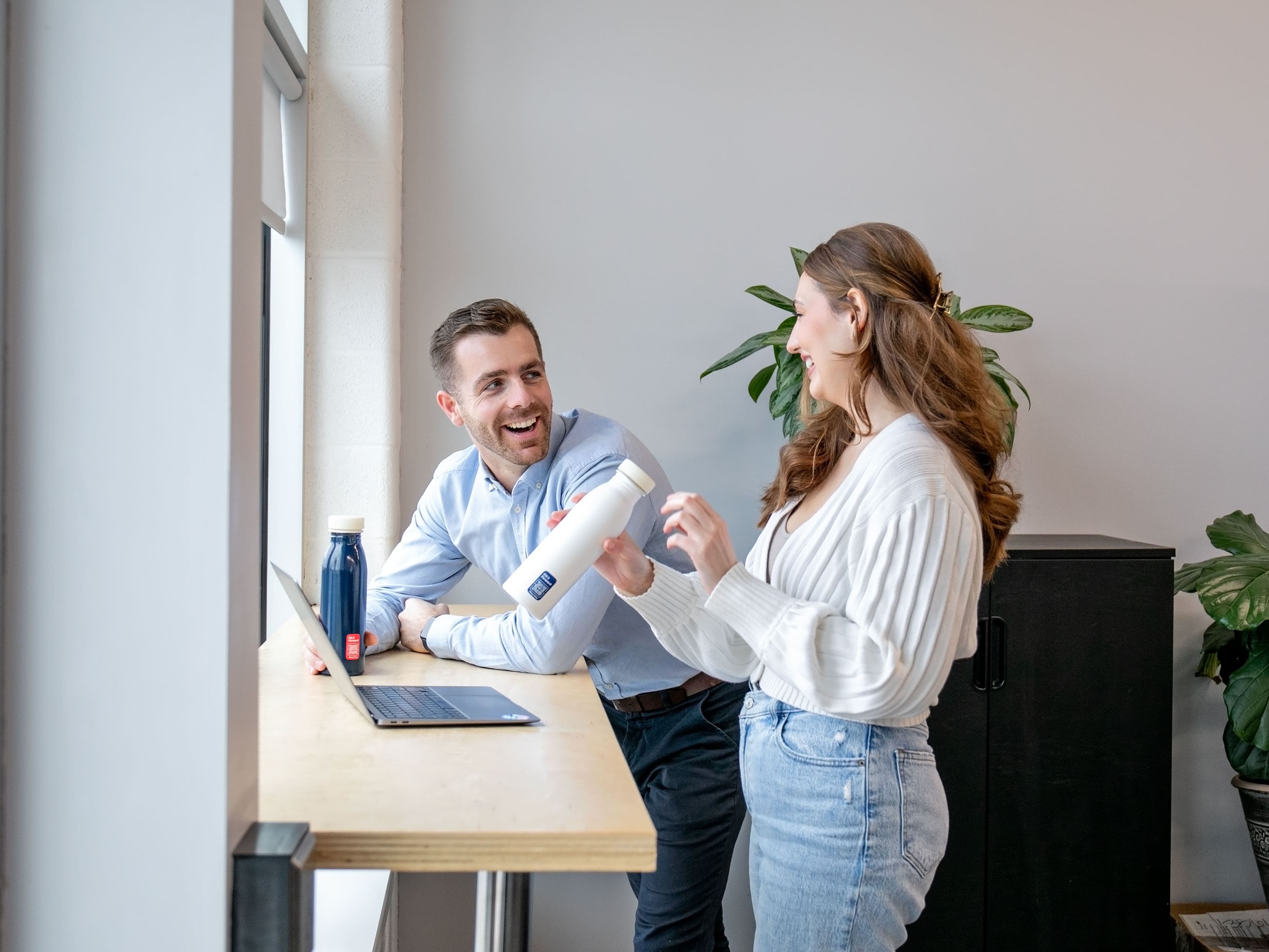 Two people standing at a table