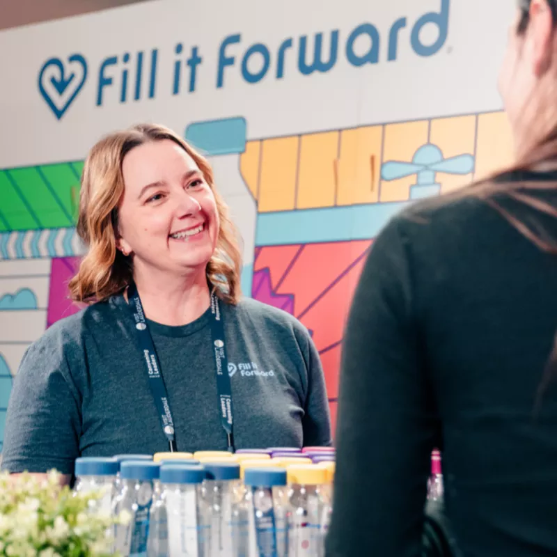Woman smiling with customer, with Cupanion bottles