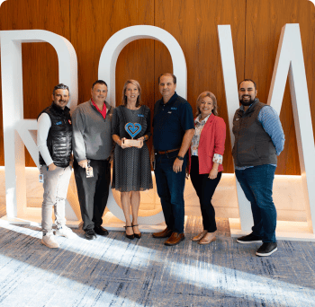 Team of Individuals holding a Fill it Forward Change maker award