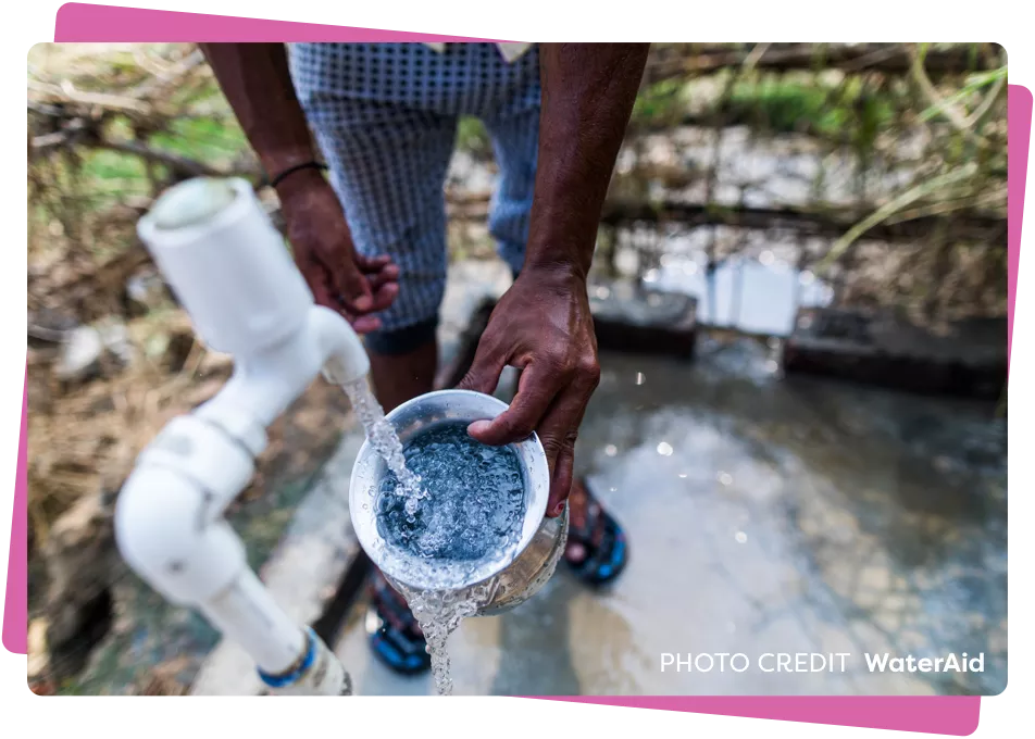 man filling up cup from a water tap