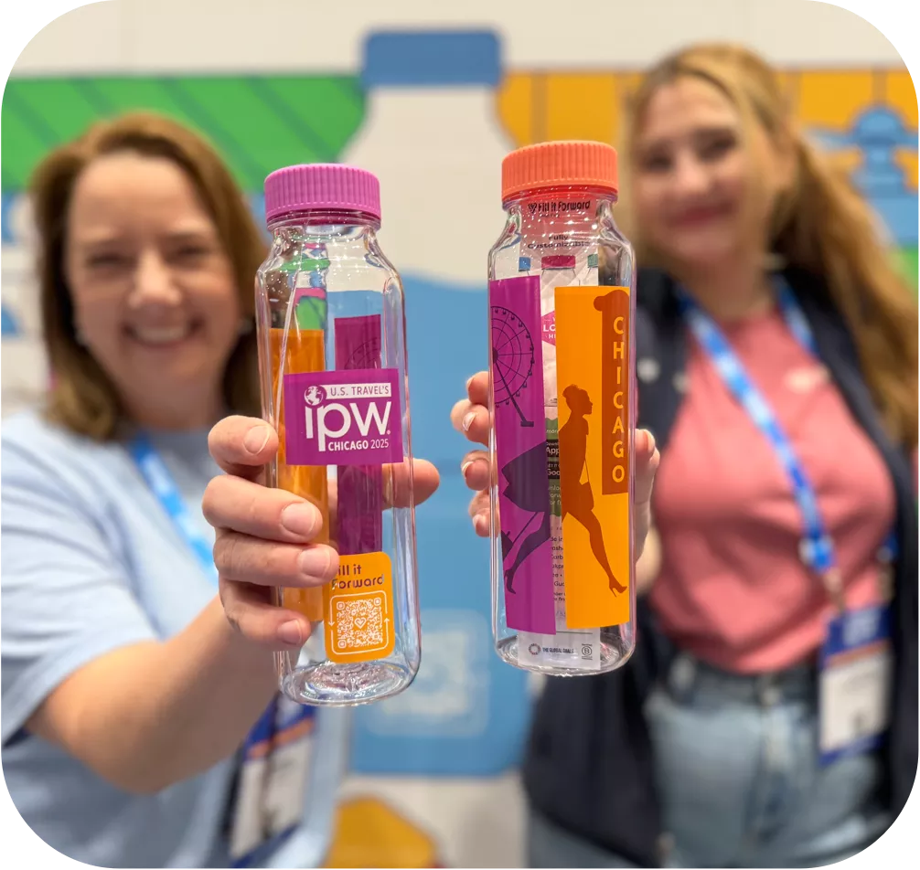 Two women holding cupanion water bottles toward the camera