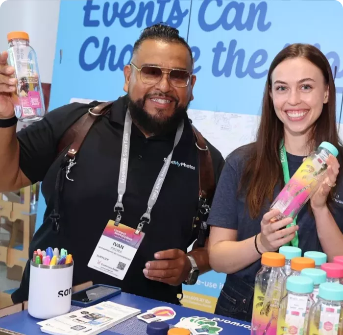 2 individuals smiling holding Cupanion water bottles
