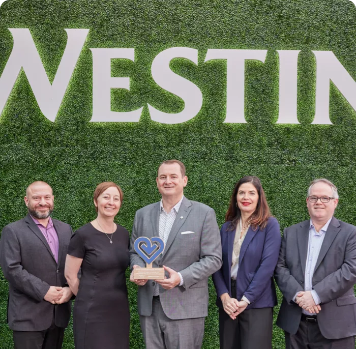 Team of Westin employees holding a Fill it Forward Changemaker award