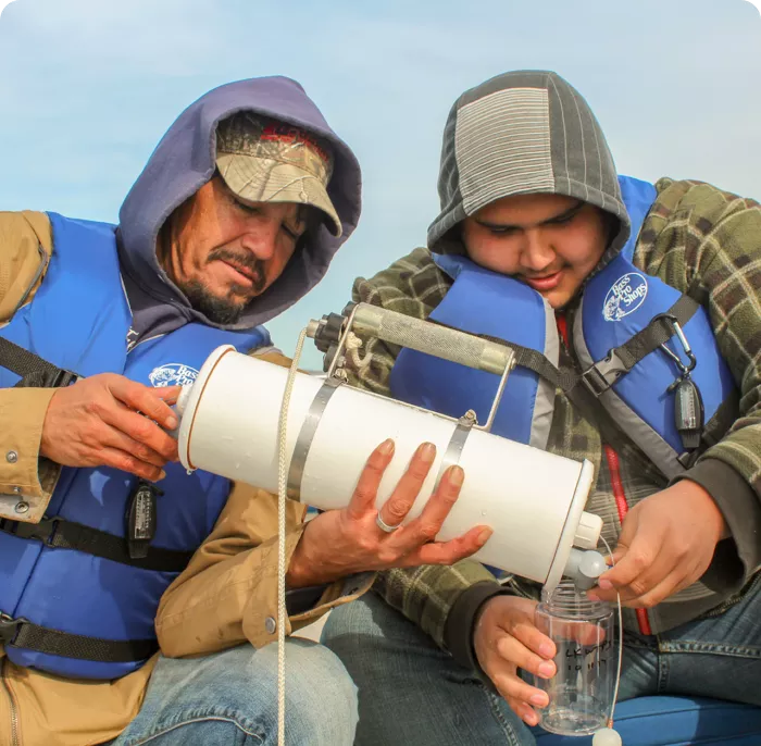 two man holding a water filter for safe drinking water