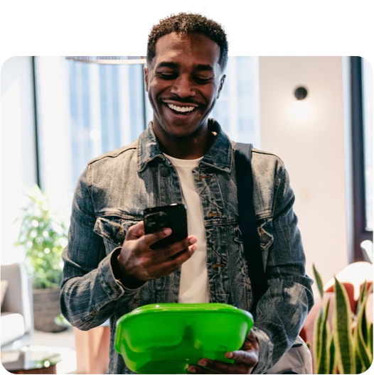 Man scanning reusable container with fill it forward borrow technology