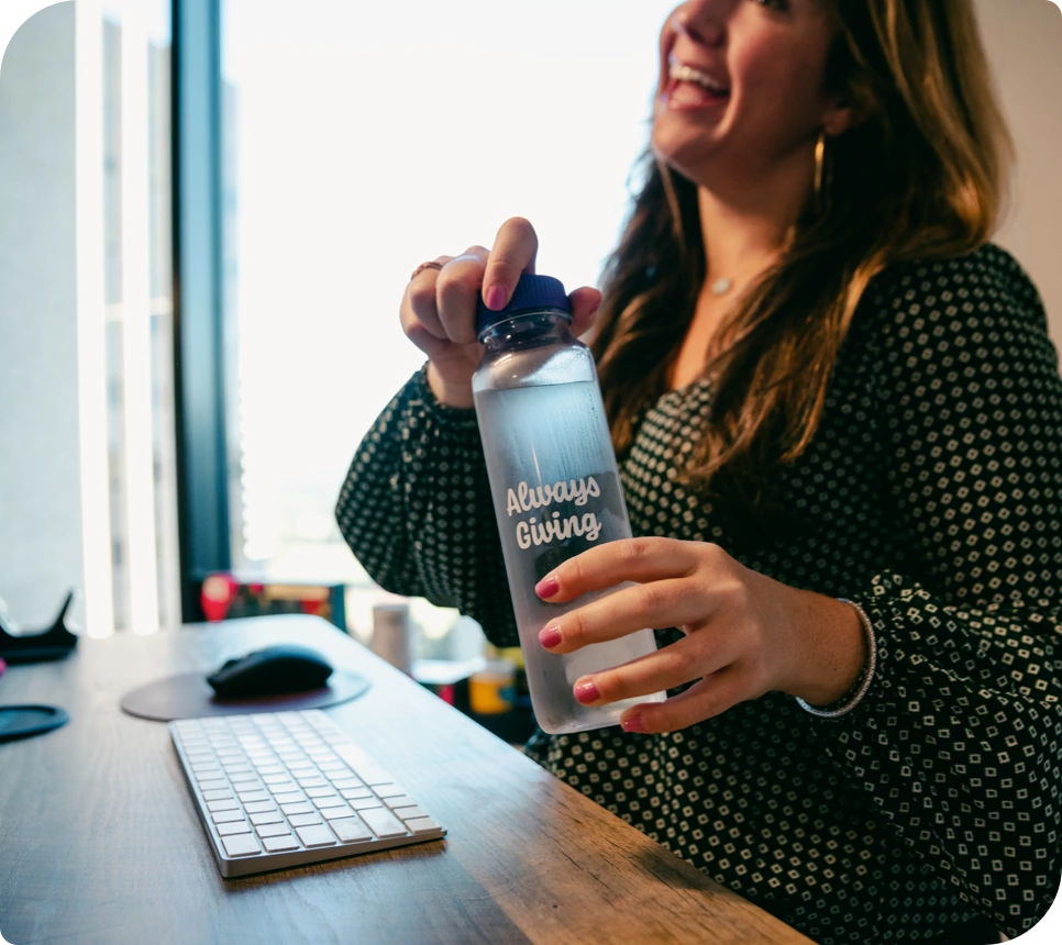 Woman holding Cupanion bottle towards camera