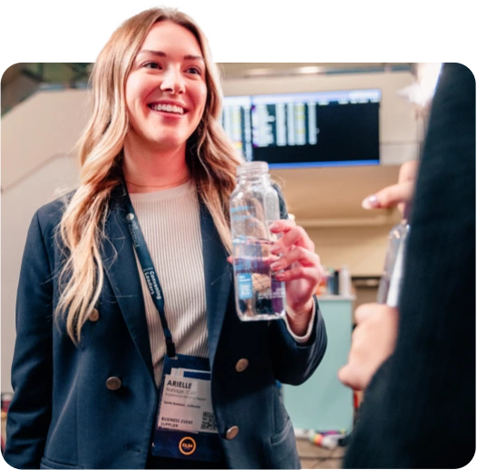 Woman smiling with cupanion bottle at a tradeshow